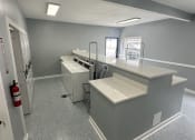 Thumbnail 15 of 31 - an empty room with a counter top and appliances in a building
